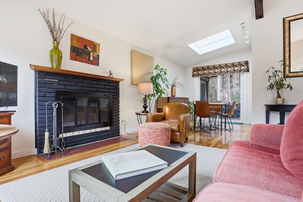 69 Robbins Road Sudbury, MA 01776 - Photo 6 of 35 a living room with furniture a flat screen tv and a fireplace