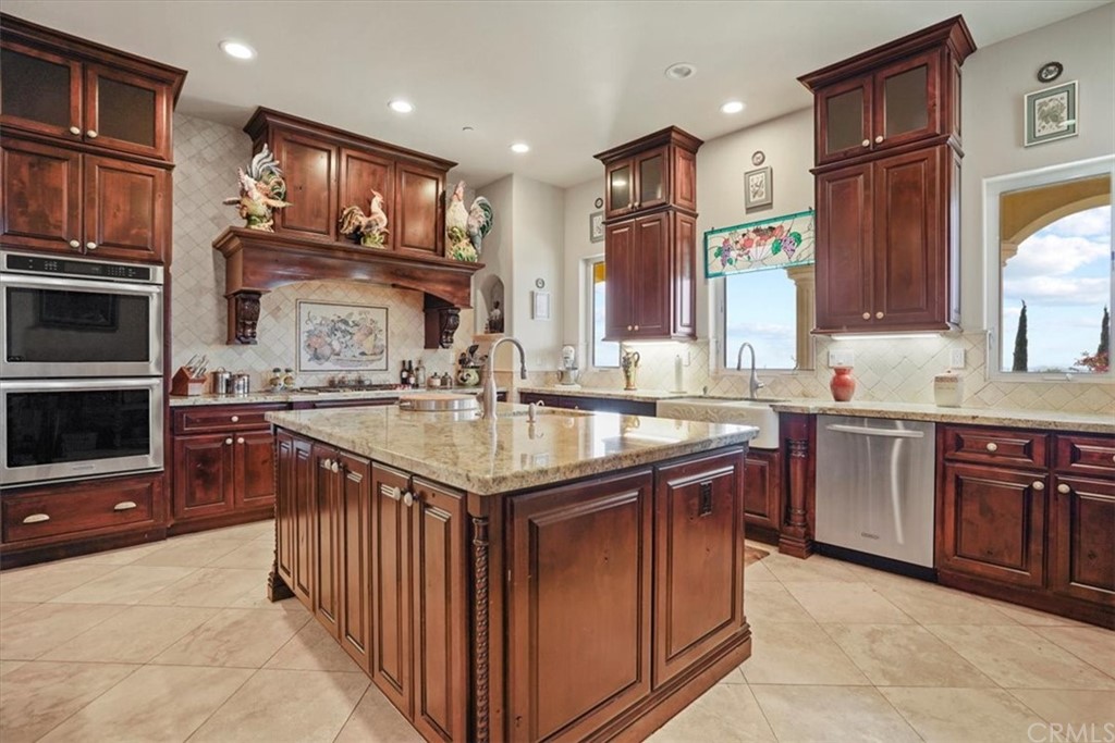 39150 Vía De Oro Temecula, CA 92592 - Photo 11 of 60 a kitchen with stainless steel appliances granite countertop a sink stove and cabinets
