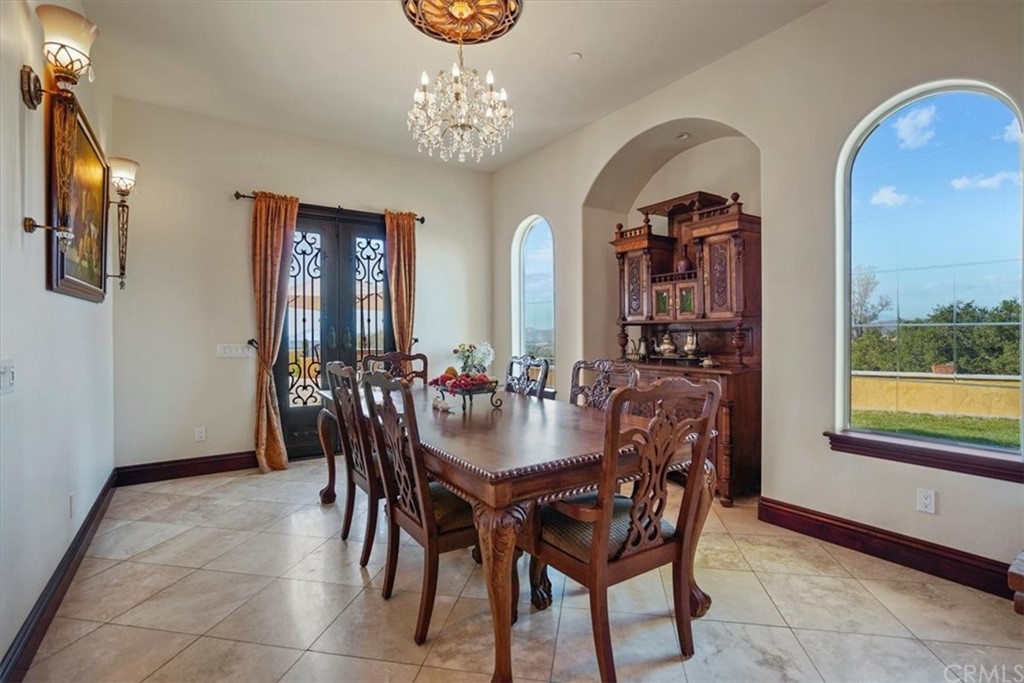 39150 Vía De Oro Temecula, CA 92592 - Photo 16 of 60 a view of a dining room with furniture and a chandelier