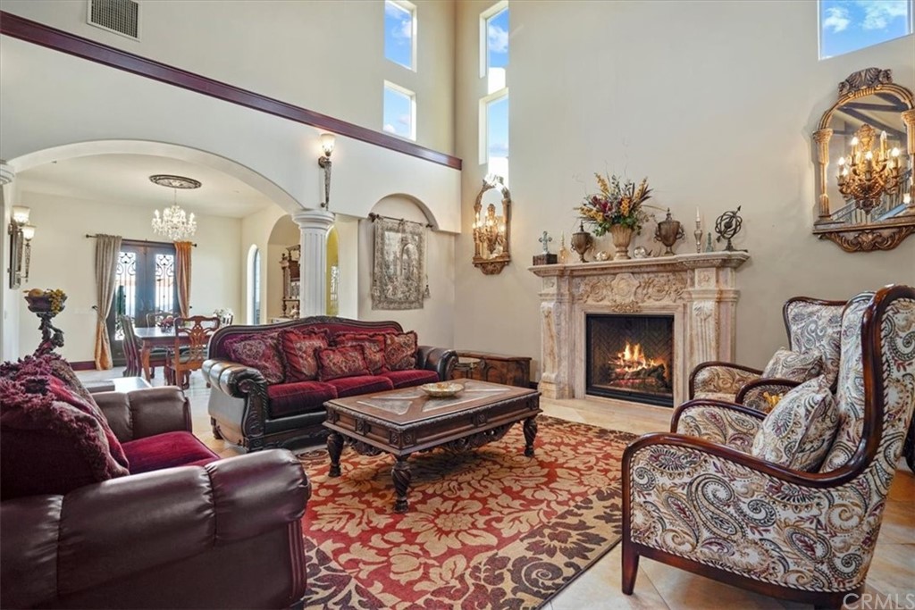 39150 Vía De Oro Temecula, CA 92592 - Photo 17 of 60 a living room with furniture a rug a fireplace and a window