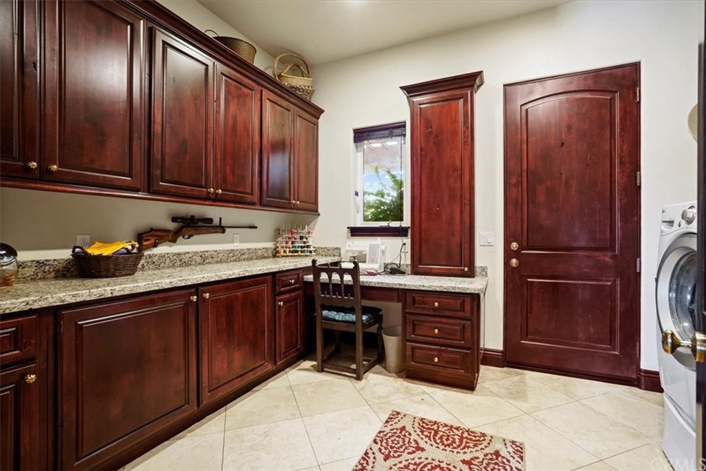 39150 Vía De Oro Temecula, CA 92592 - Photo 22 of 60 a kitchen with stainless steel appliances granite countertop wooden cabinets a refrigerator and a sink