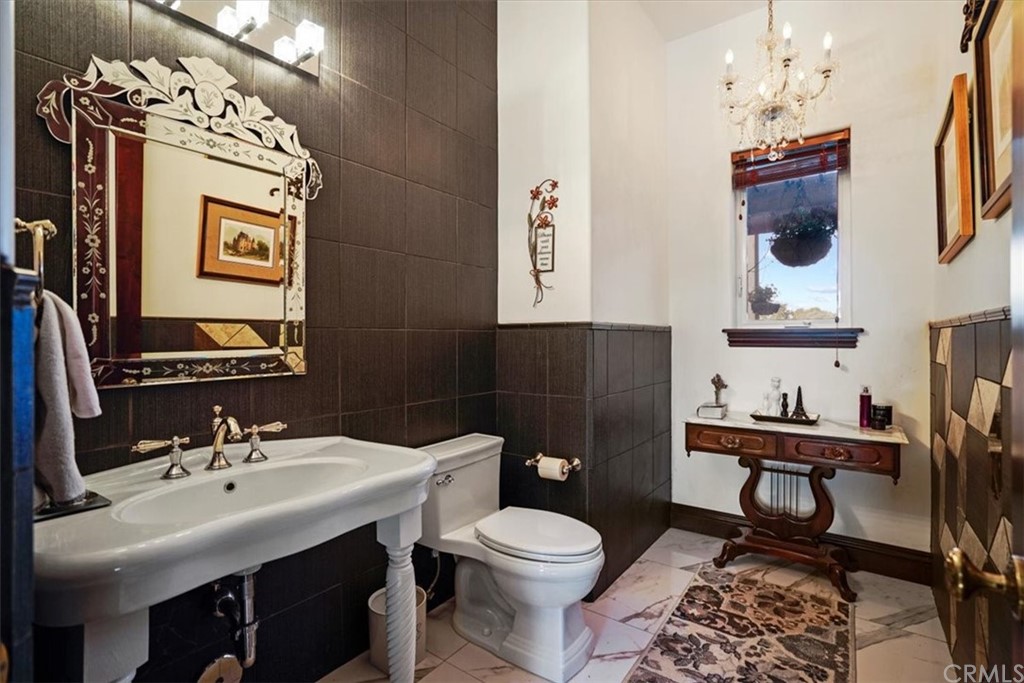 39150 Vía De Oro Temecula, CA 92592 - Photo 23 of 60 a bathroom with a toilet a sink and mirror