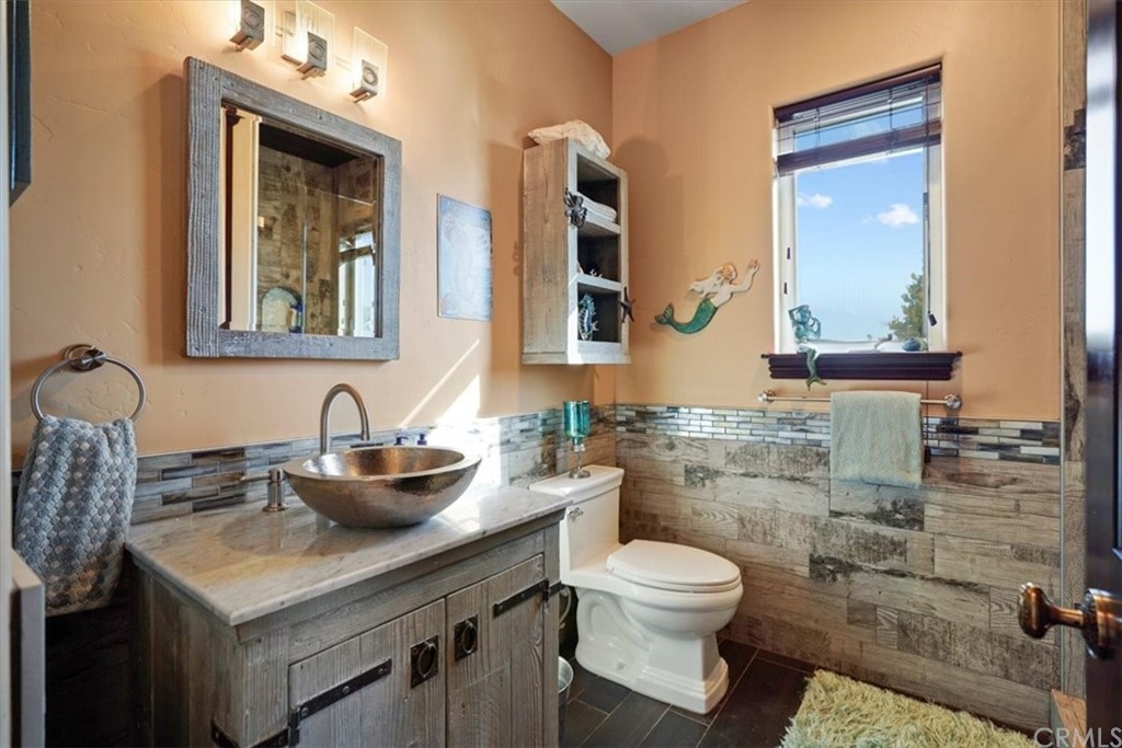39150 Vía De Oro Temecula, CA 92592 - Photo 24 of 60 a bathroom with a toilet sink and mirror