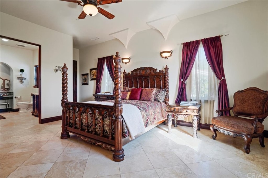 39150 Vía De Oro Temecula, CA 92592 - Photo 25 of 60 a bedroom with a bed and a chandelier