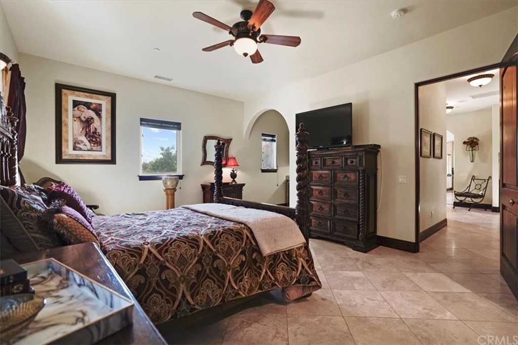 39150 Vía De Oro Temecula, CA 92592 - Photo 26 of 60 a bedroom with a bed and a flat tv screen on dresser