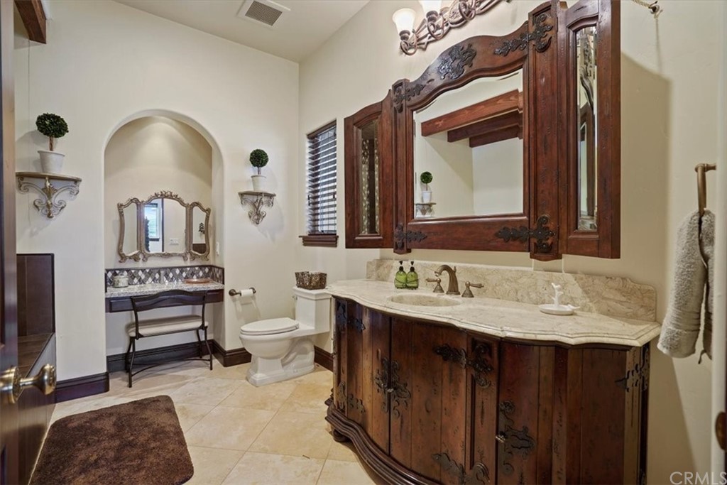 39150 Vía De Oro Temecula, CA 92592 - Photo 27 of 60 a bathroom with a double vanity sink and a mirror