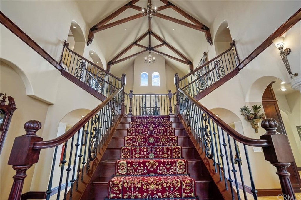 39150 Vía De Oro Temecula, CA 92592 - Photo 30 of 60 a view of staircase with lots of frames on wall and a chandelier
