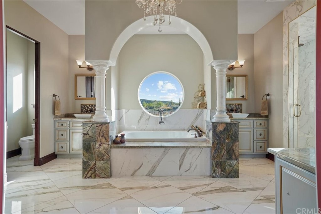 39150 Vía De Oro Temecula, CA 92592 - Photo 34 of 60 a living room with a sink and a mirror