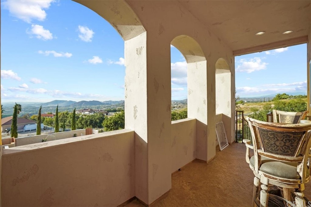 39150 Vía De Oro Temecula, CA 92592 - Photo 37 of 60 a living room with furniture and a floor to ceiling window