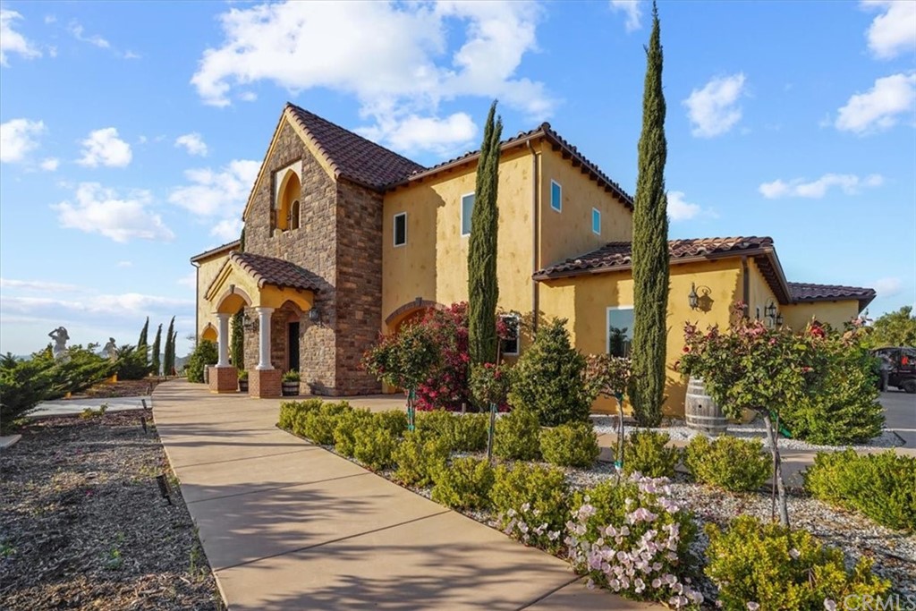 39150 Vía De Oro Temecula, CA 92592 - Photo 4 of 60 a front view of a house with a yard and potted plants