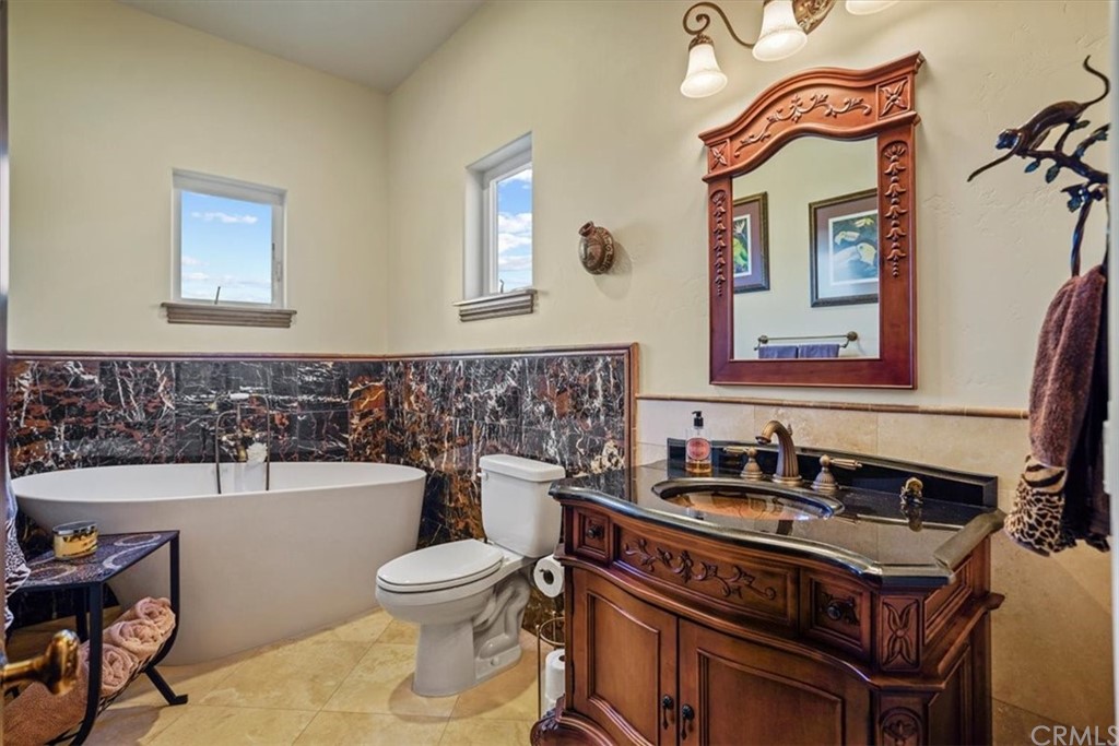 39150 Vía De Oro Temecula, CA 92592 - Photo 41 of 60 a bathroom with a toilet a sink and a mirror