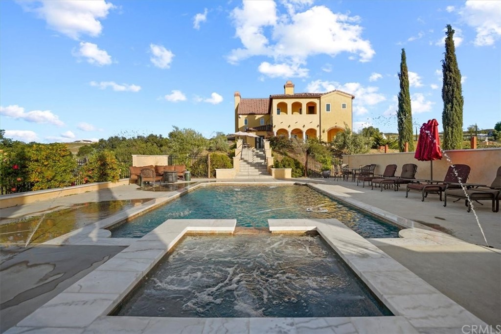 39150 Vía De Oro Temecula, CA 92592 - Photo 46 of 60 a view of a swimming pool with a lounge chair and floor to ceiling window
