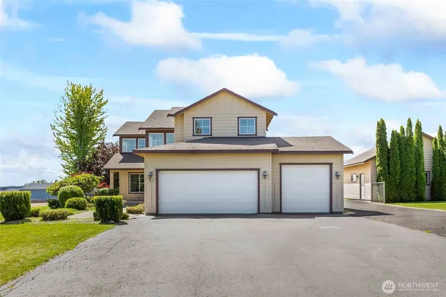 a front view of a house with a yard and garage