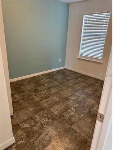 a view of a room with an empty space and window