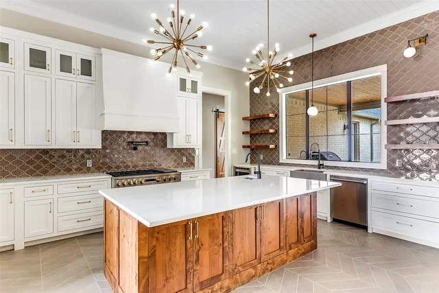 a kitchen with granite countertop a stove and a white cabinet