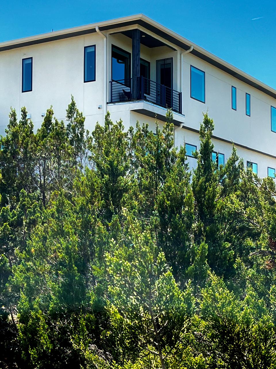 2050 Lohmans Spur Road, Unit 1302 Lakeway, TX 78734 - Photo 15 of 18 a front view of a house with garden