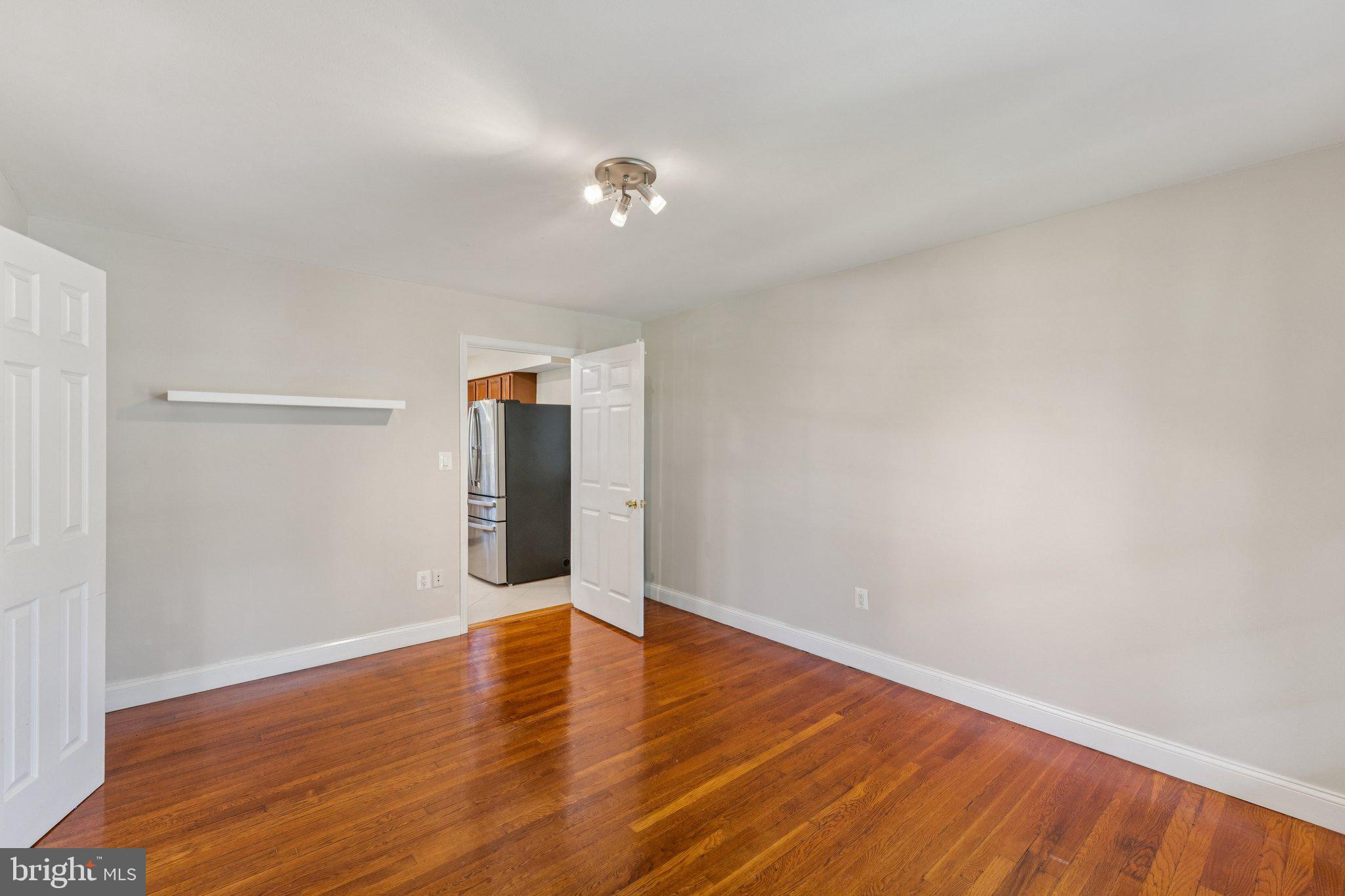 1900 Briggs Road Silver Spring, MD 20906 - Photo 15 of 44 a view of an empty room with wooden floor