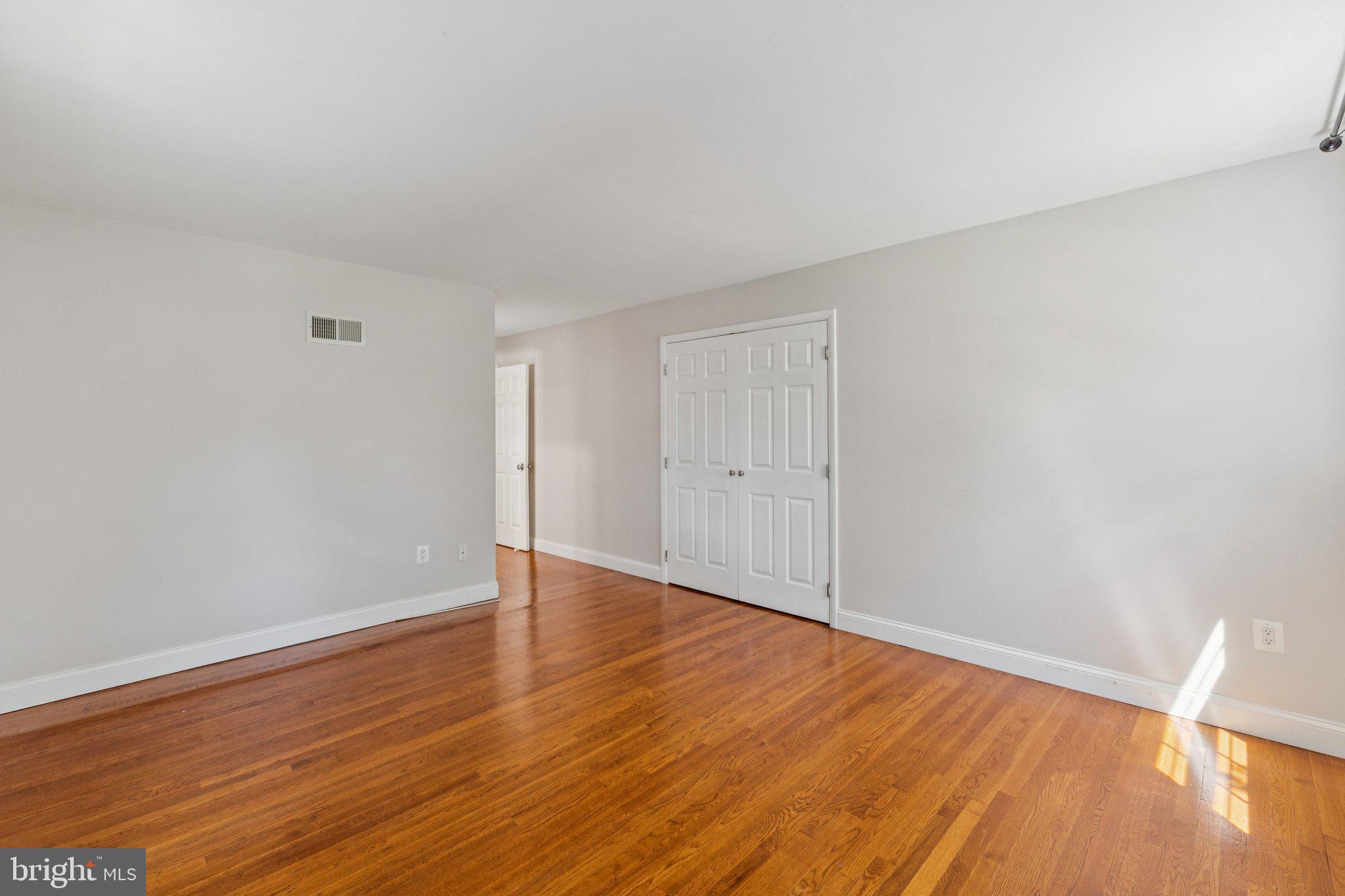 1900 Briggs Road Silver Spring, MD 20906 - Photo 20 of 44 a view of an empty room with wooden floor