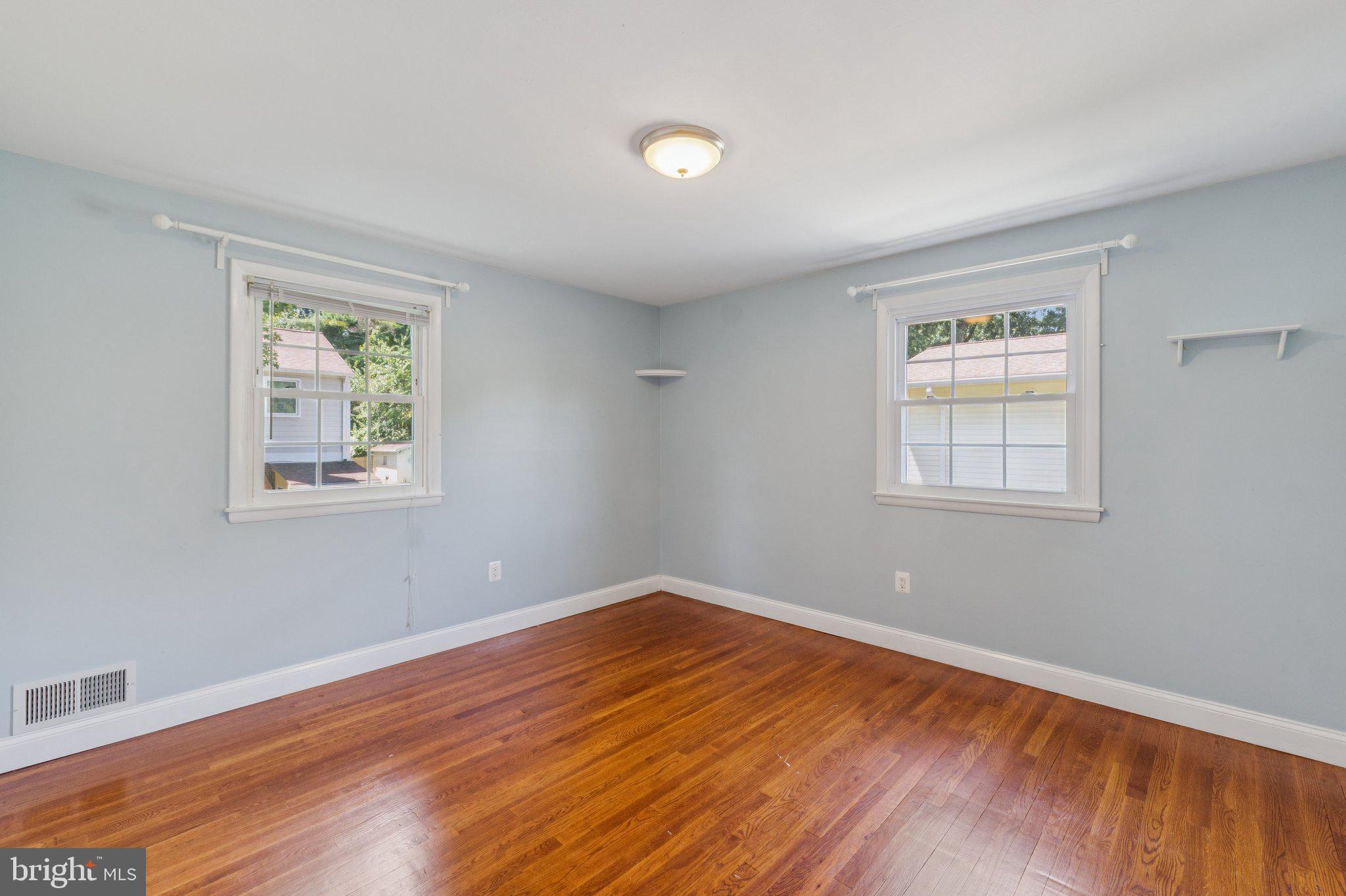 1900 Briggs Road Silver Spring, MD 20906 - Photo 23 of 44 a view of empty room with wooden floor and fan