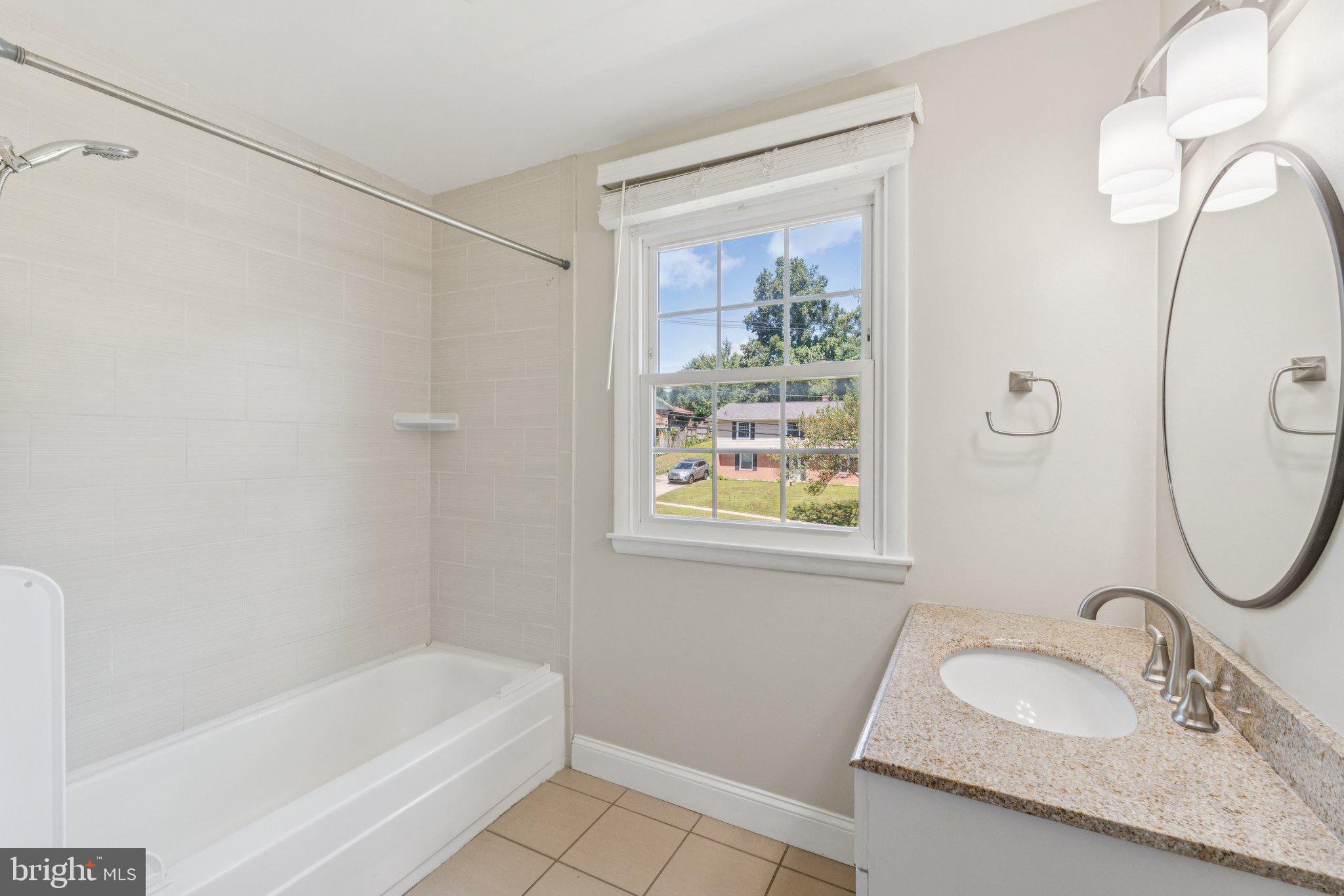 1900 Briggs Road Silver Spring, MD 20906 - Photo 27 of 44 a bathroom with a granite countertop sink and a mirror