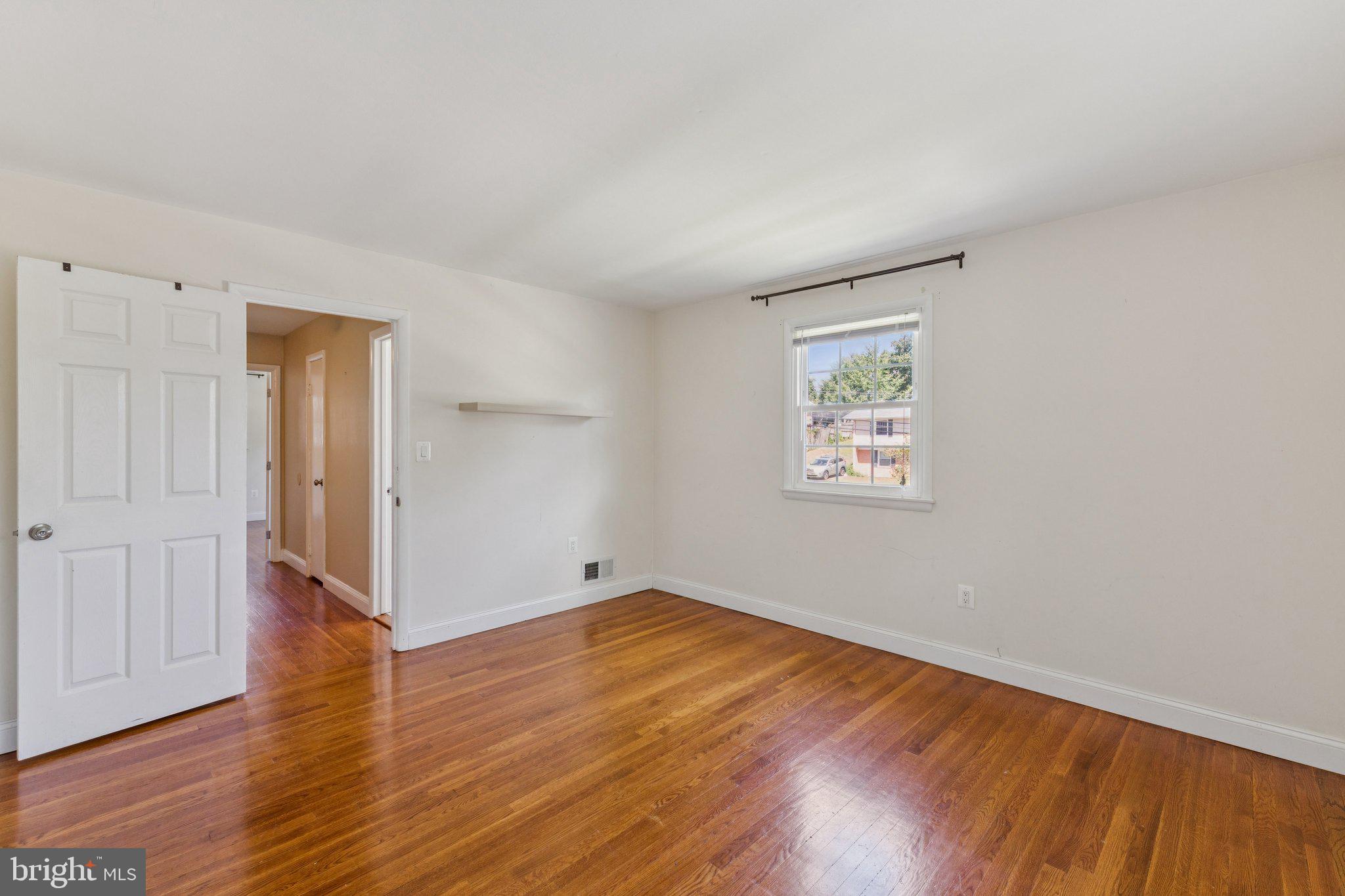 1900 Briggs Road Silver Spring, MD 20906 - Photo 29 of 44 an empty room with wooden floor and windows