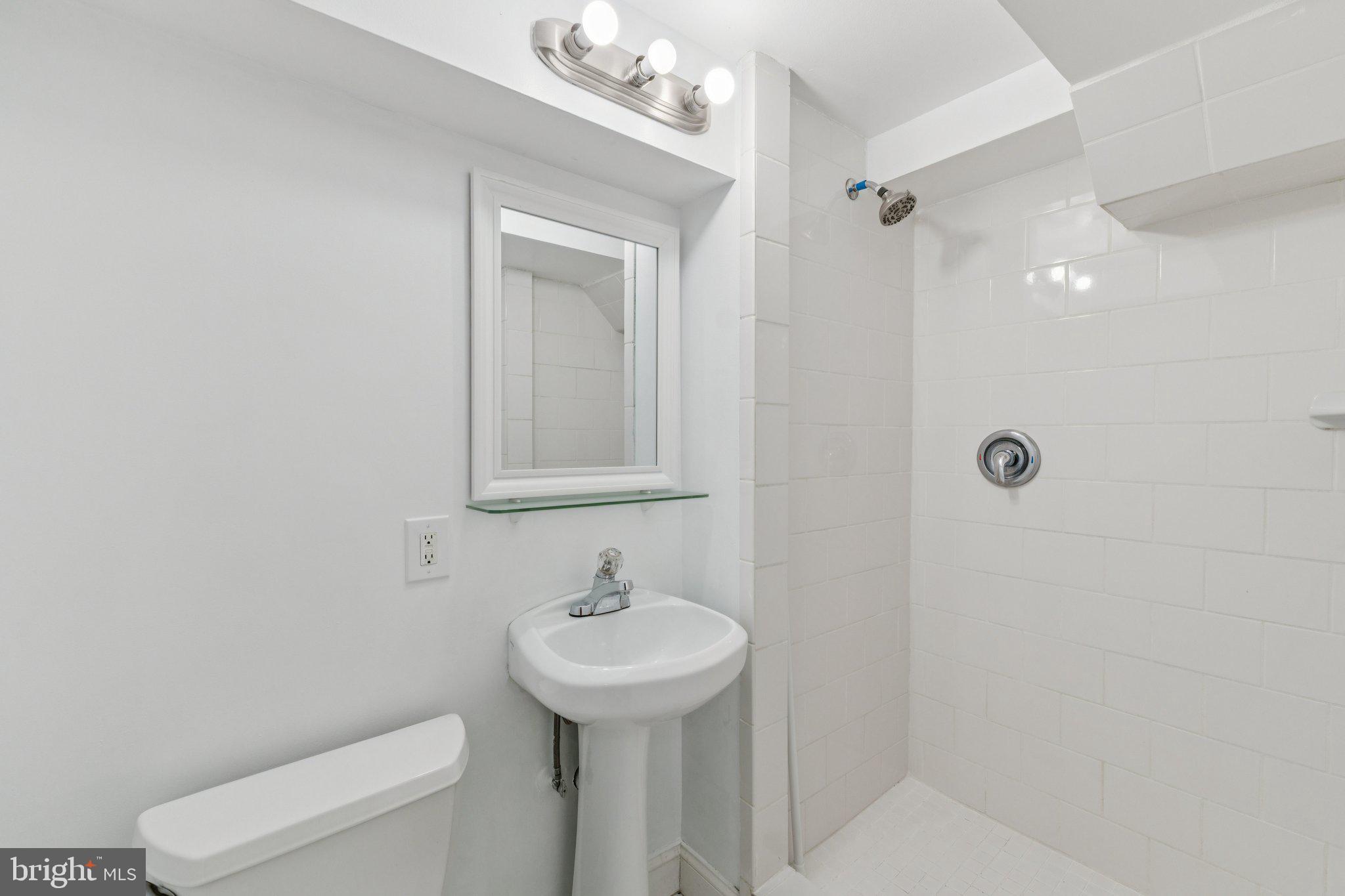 1900 Briggs Road Silver Spring, MD 20906 - Photo 36 of 44 a bathroom with a sink a toilet and shower
