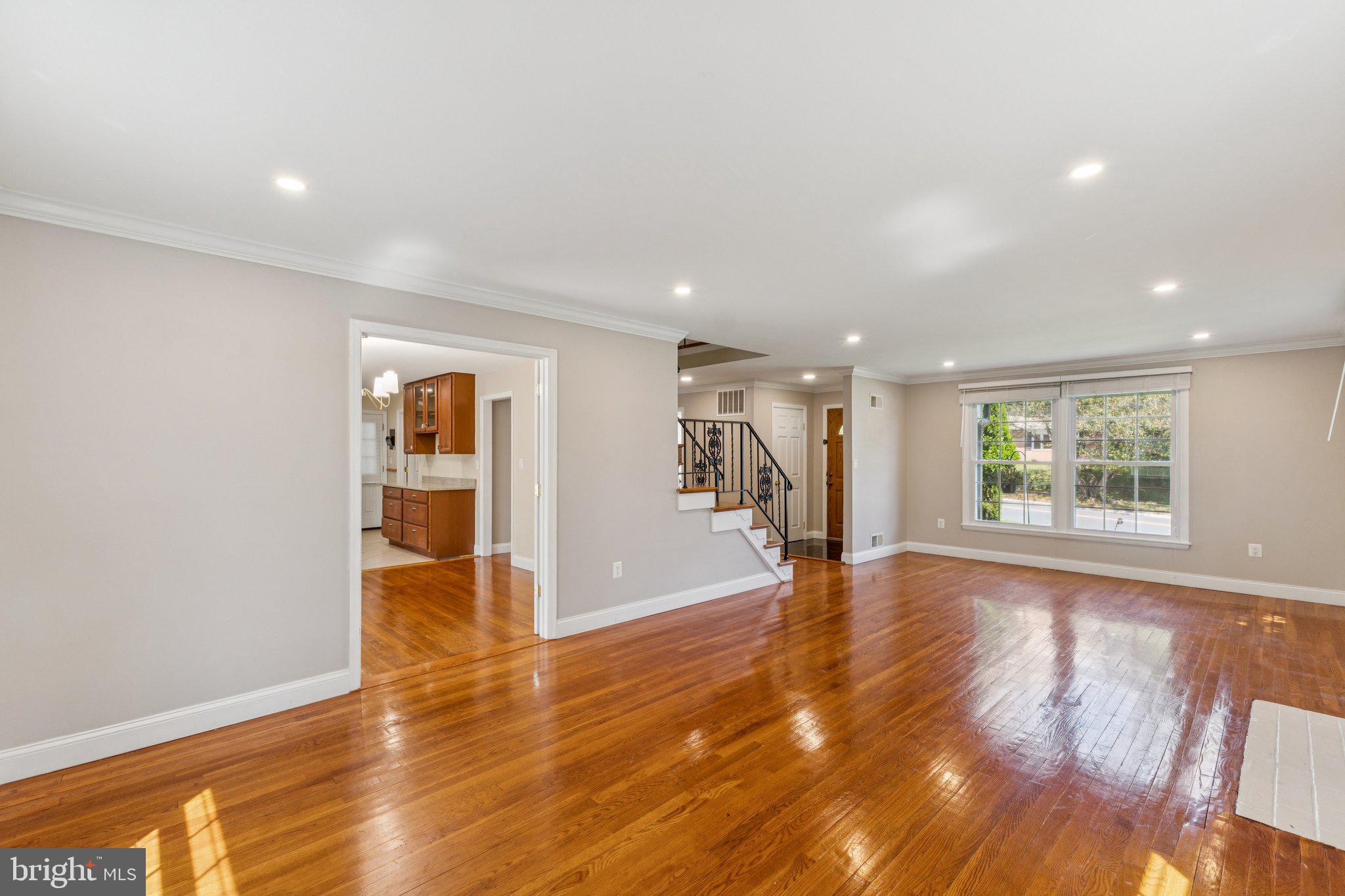 1900 Briggs Road Silver Spring, MD 20906 - Photo 6 of 44 a view of an empty room with wooden floor and a window