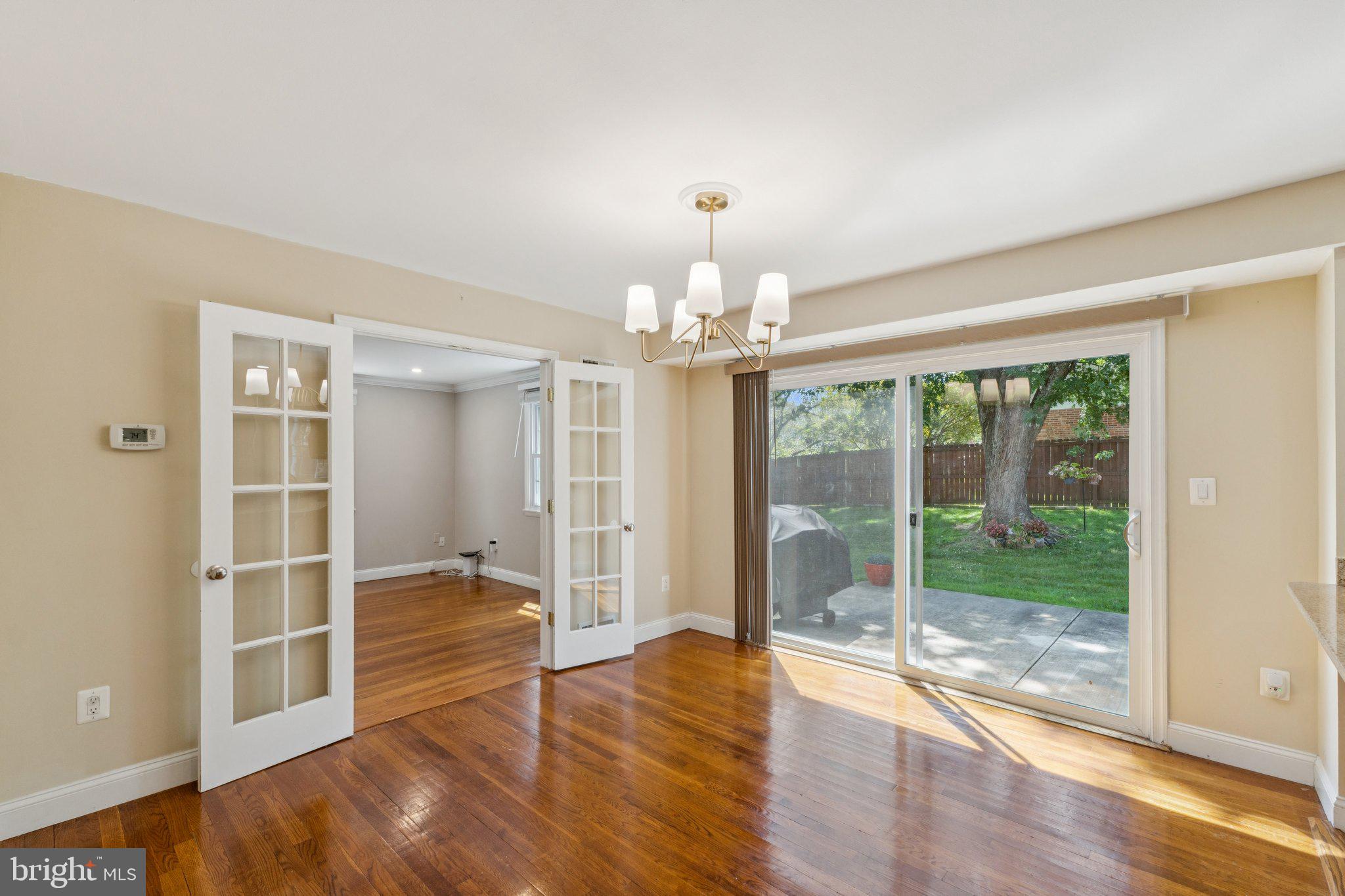 1900 Briggs Road Silver Spring, MD 20906 - Photo 7 of 44 a view of an empty room with wooden floor and a window