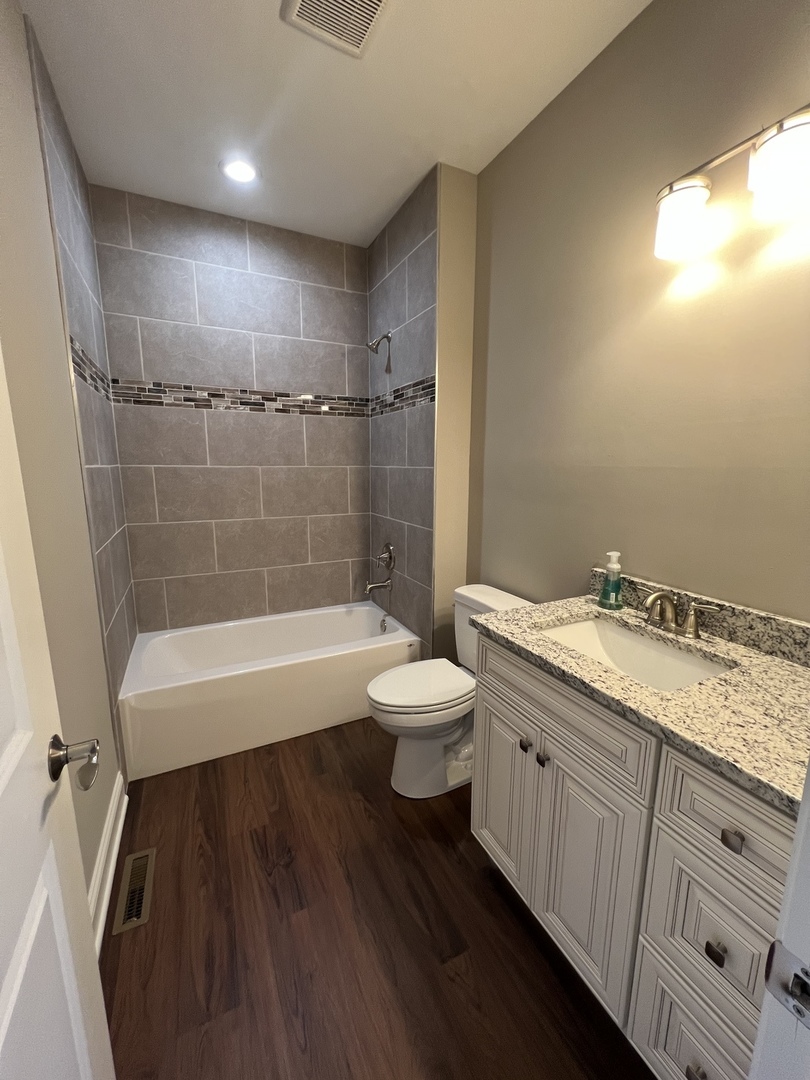 26501 Stephanie Drive Channahon, IL 60410 - Photo 3 of 14 a bathroom with a granite countertop sink toilet a mirror and shower