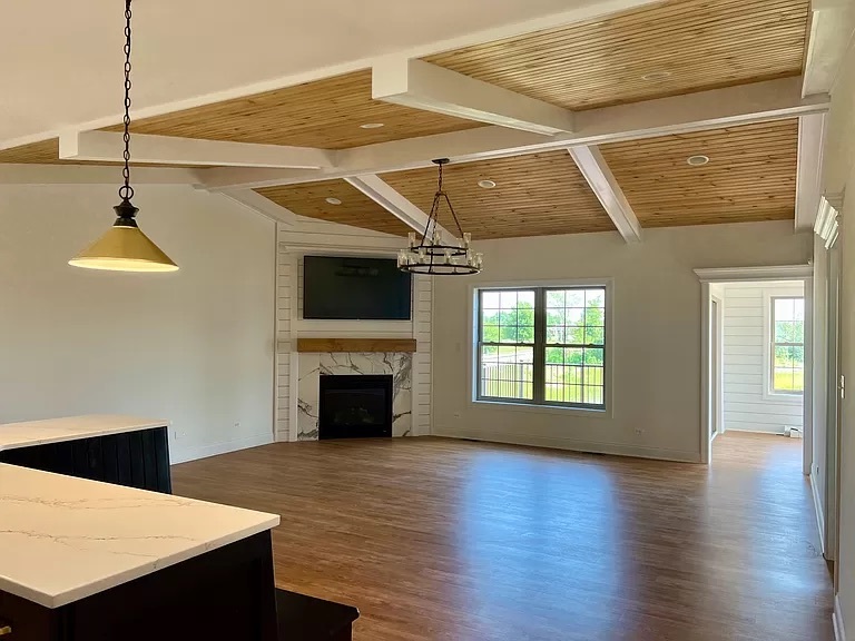 26501 Stephanie Drive Channahon, IL 60410 - Photo 10 of 14 a view of an empty room with wooden floor fireplace and a window
