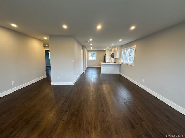 5 Linwood Road North, Unit 2 Port Washington, NY 11050 - Photo 5 of 12 Unfurnished living room with dark wood finished floors and recessed lighting