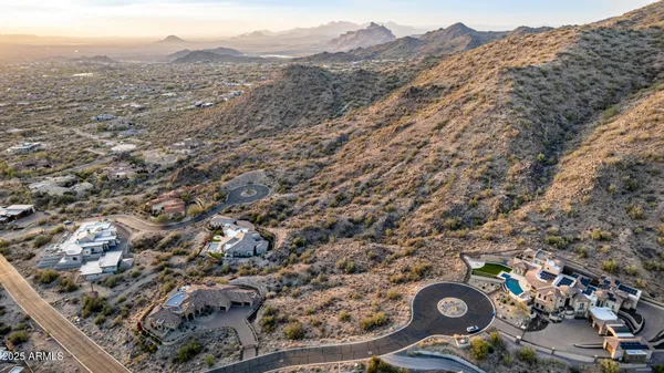 a view of a dry yard with mountains in the background