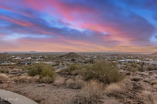 a view of a city with lush green forest