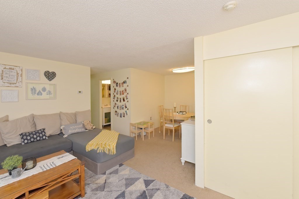 32 Silver Hill Lane, Unit 1 Natick, MA 01760 - Photo 11 of 36 a living room with furniture and a table