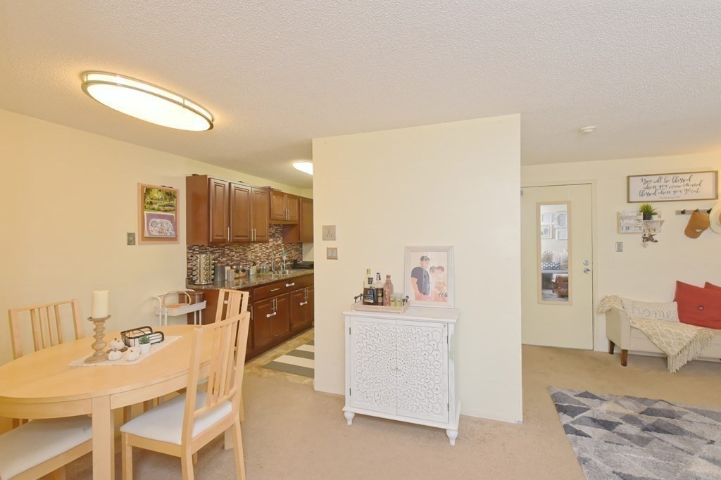 32 Silver Hill Lane, Unit 1 Natick, MA 01760 - Photo 13 of 36 a living room with furniture and kitchen view