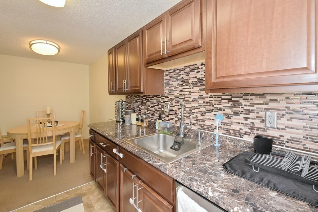 32 Silver Hill Lane, Unit 1 Natick, MA 01760 - Photo 16 of 36 a kitchen with a sink and cabinets