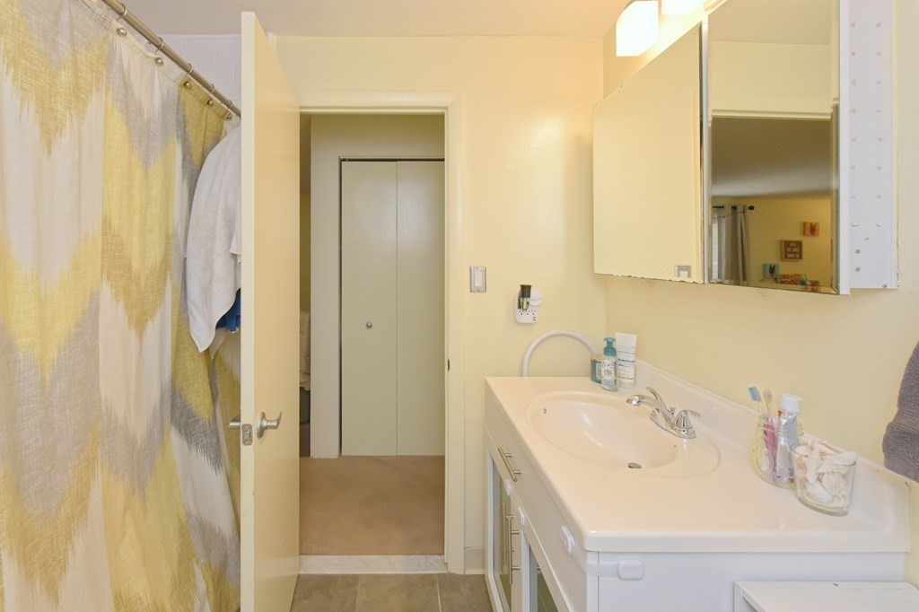 32 Silver Hill Lane, Unit 1 Natick, MA 01760 - Photo 18 of 36 a bathroom with a sink and a mirror
