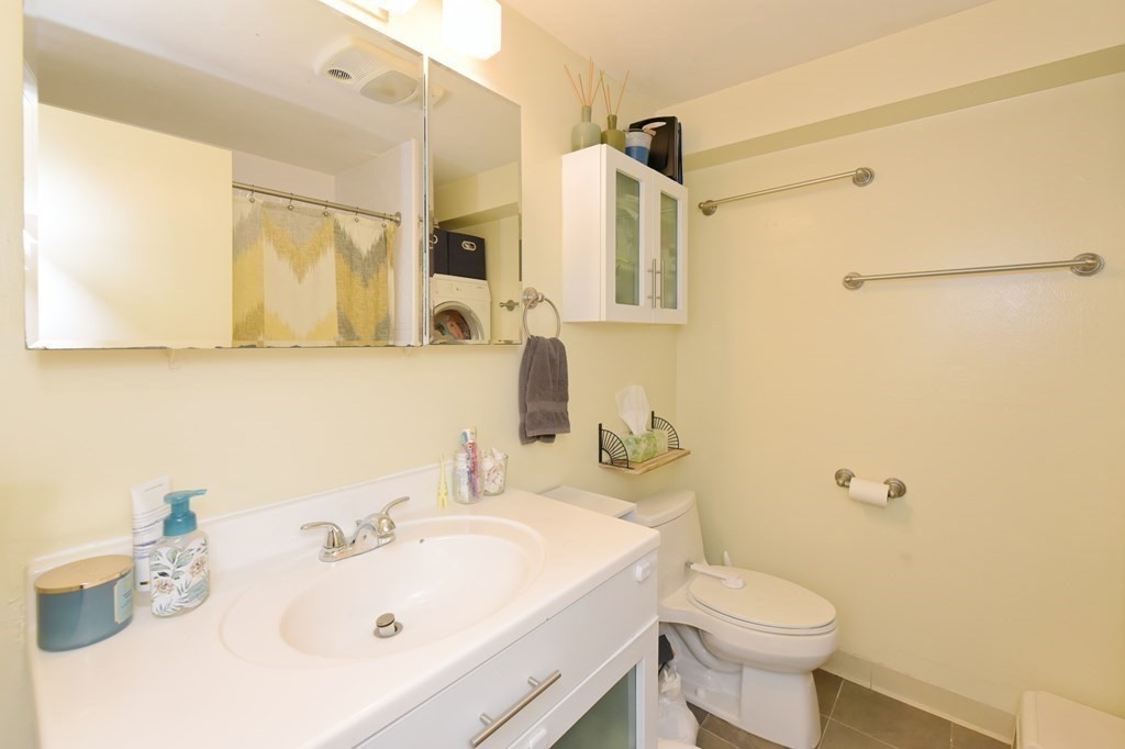 32 Silver Hill Lane, Unit 1 Natick, MA 01760 - Photo 19 of 36 a bathroom with a sink a toilet and shower