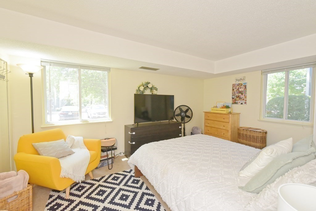 32 Silver Hill Lane, Unit 1 Natick, MA 01760 - Photo 21 of 36 a bedroom with a bed and wooden floor