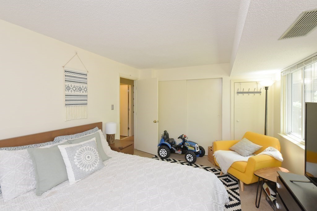 32 Silver Hill Lane, Unit 1 Natick, MA 01760 - Photo 22 of 36 a bedroom with a bed and wooden floor