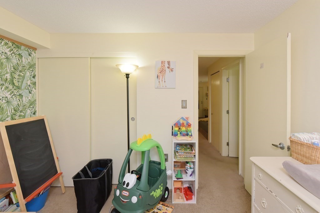 32 Silver Hill Lane, Unit 1 Natick, MA 01760 - Photo 25 of 36 a room with furniture and a gate