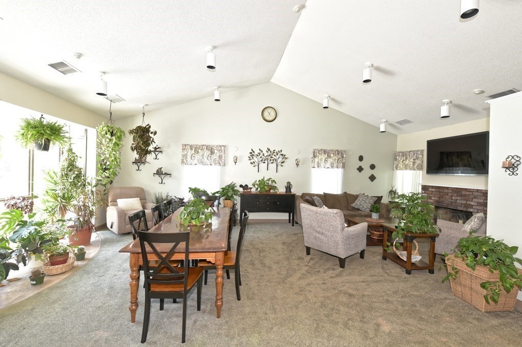 32 Silver Hill Lane, Unit 1 Natick, MA 01760 - Photo 28 of 36 a dining room with furniture and a flat screen tv
