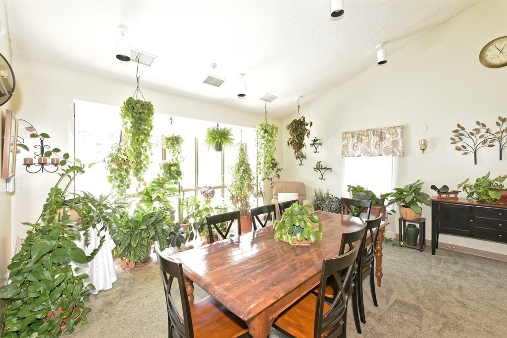 32 Silver Hill Lane, Unit 1 Natick, MA 01760 - Photo 29 of 36 a view of a dining room with furniture and chandelier