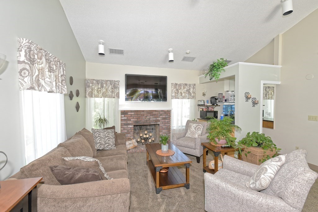 32 Silver Hill Lane, Unit 1 Natick, MA 01760 - Photo 30 of 36 a living room with furniture and a fireplace