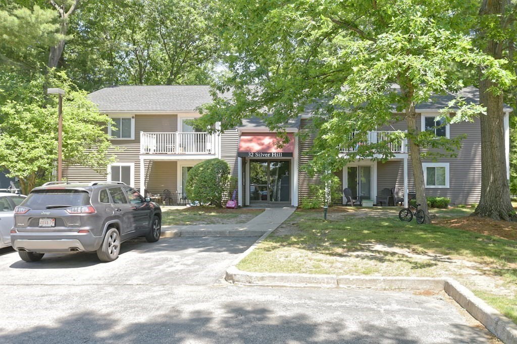 32 Silver Hill Lane, Unit 1 Natick, MA 01760 - Photo 4 of 36 a view of a car park in front of a house