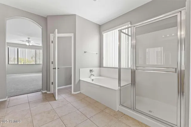 a spacious bathroom with a bathtub shower and toilet