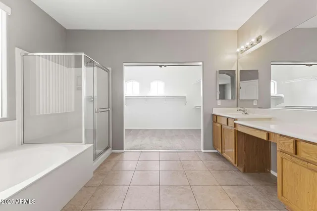 a spacious bathroom with a granite countertop sink a toilet and bathtub