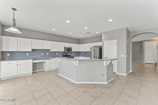a kitchen with stainless steel appliances a refrigerator sink and cabinets