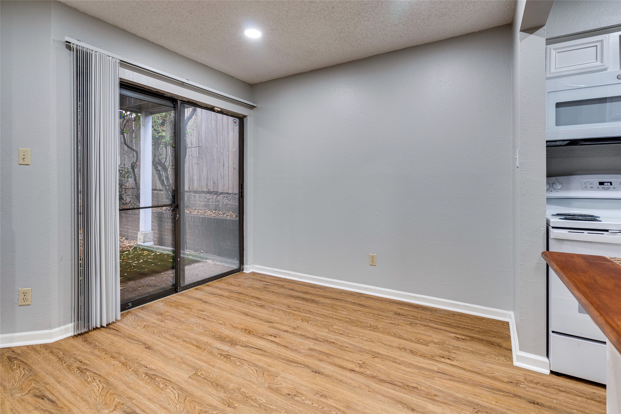 1808 Rio Grande Street, Unit 6 Austin, TX 78701 - Photo 6 of 29 Spare room with a textured ceiling, light wood-type flooring, and recessed lighting
