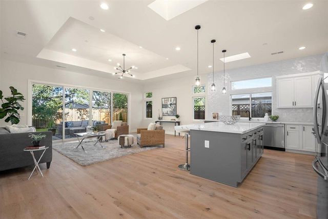 a large kitchen with lots of counter space dining table and chairs